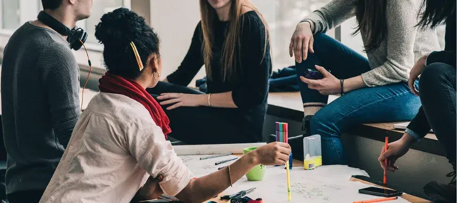 Students sitting around a table discussing work
