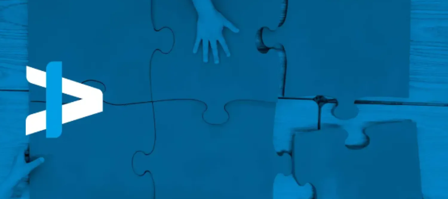 overhead view of large jigsaw on a table with many helpers