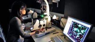 student with microscope