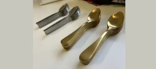 stacked gold and silver spoons