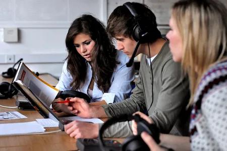 Three students one with headphones