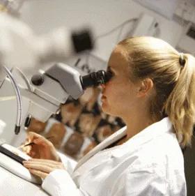 Photograph of female scientist using a microscope